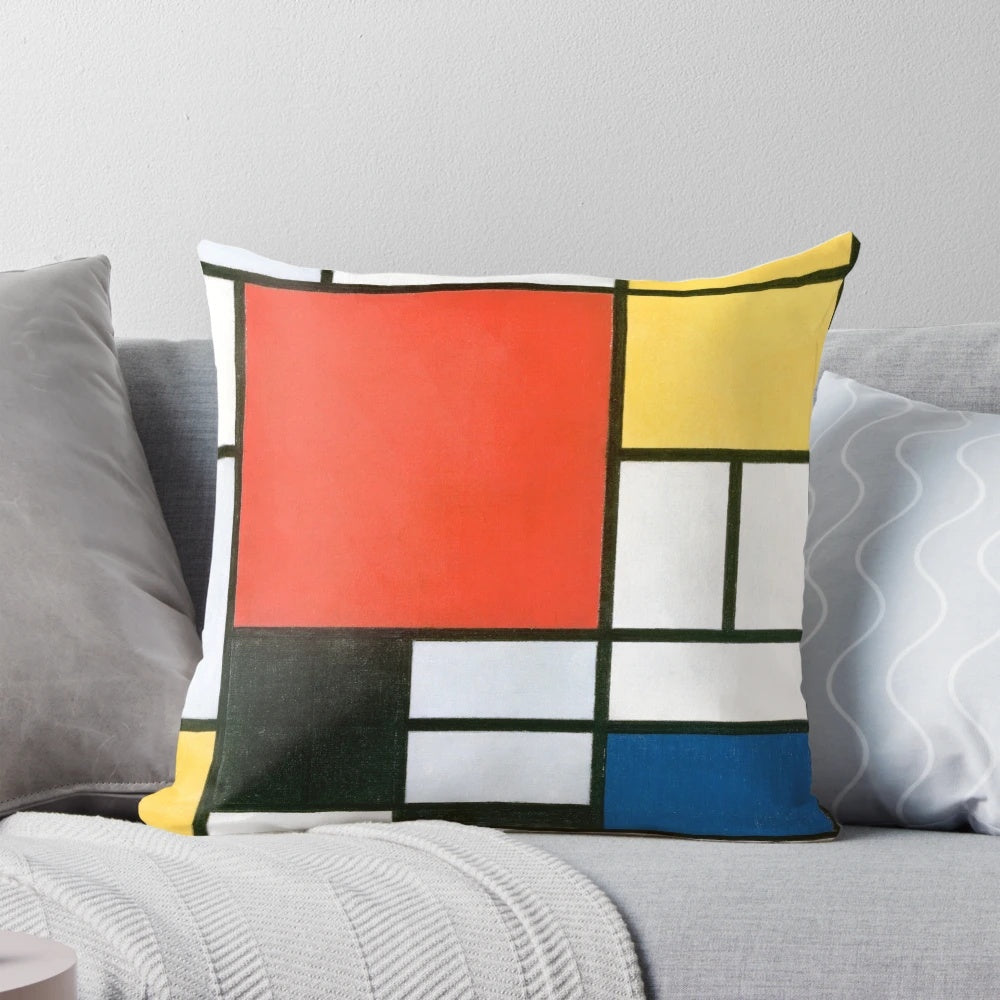 Piet Mondrian inspired abstract geometric pillow with bold red, yellow, blue, and black color composition