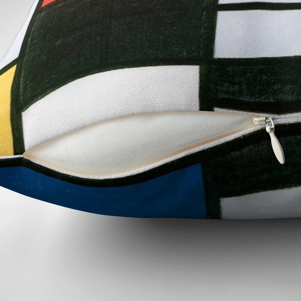 Piet Mondrian inspired abstract geometric pillow with bold red, yellow, blue, and black color composition