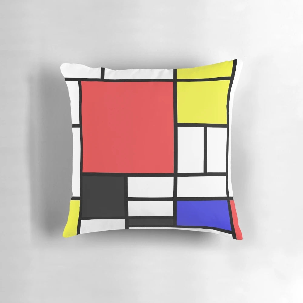 Mondrian-style pillow with black, white, and primary color geometric pattern, inspired by the iconic works of Dutch artist Piet Mondrian.
