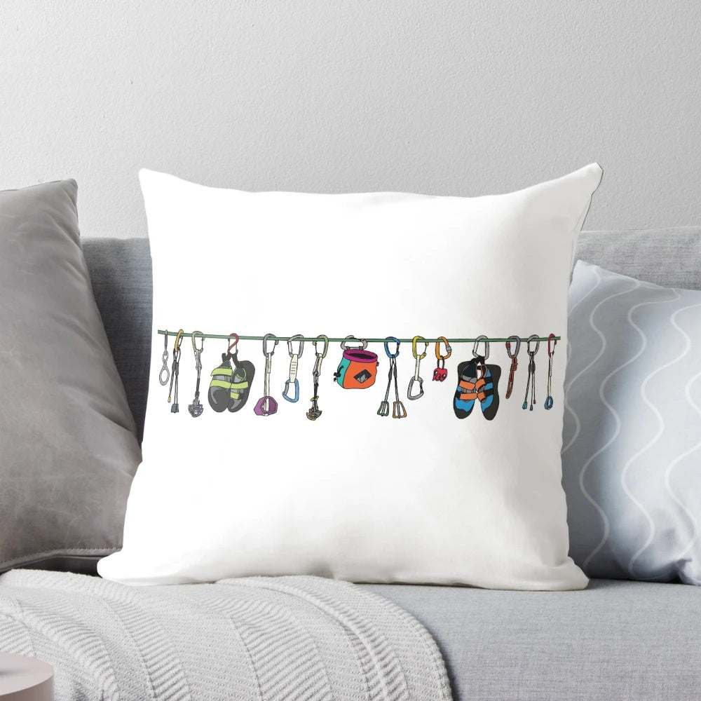 Pillow with colorful illustrations of climbing gear such as ropes, carabiners, and shoes