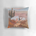 Decorative throw pillow featuring a pinup-style jackalope cowgirl on a cactus-filled desert background.