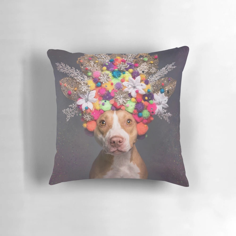 Frida the Pit Bull wearing a colorful flower crown on a decorative pillow