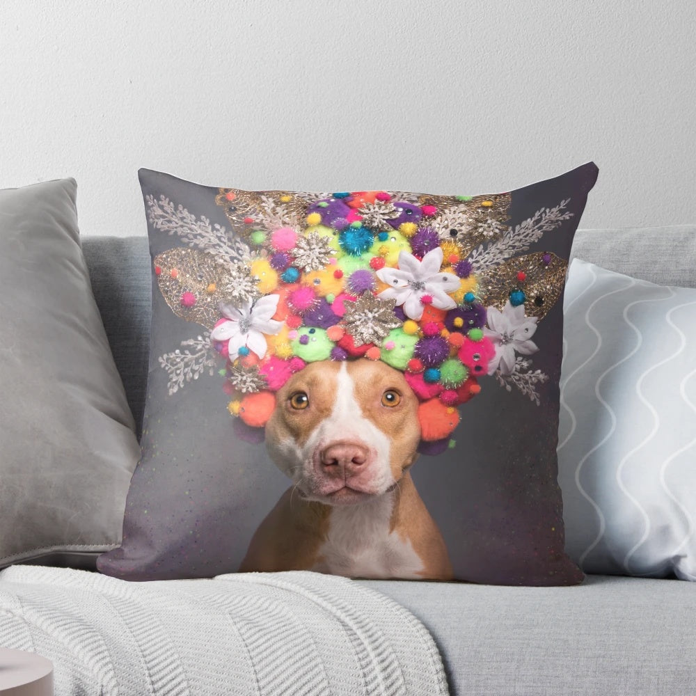 Frida the Pit Bull wearing a colorful flower crown on a decorative pillow