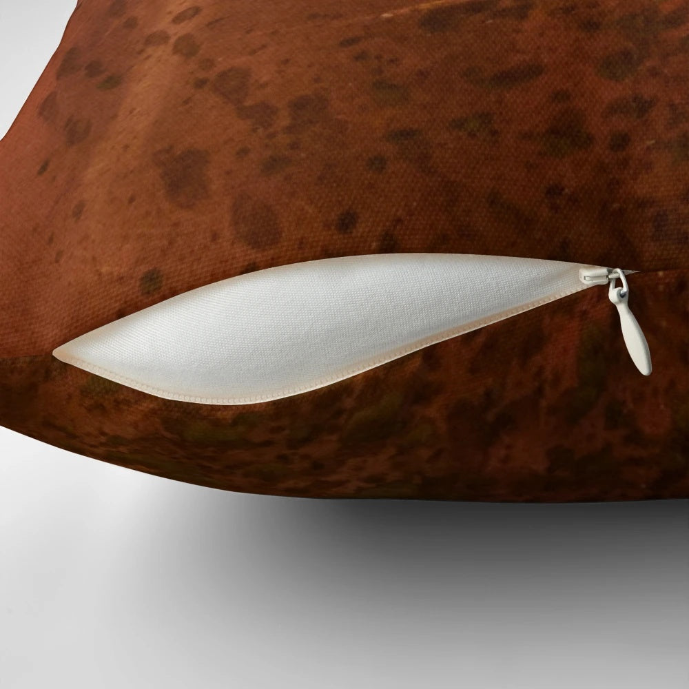 Pitted copper metal pillow with a distressed, aged appearance