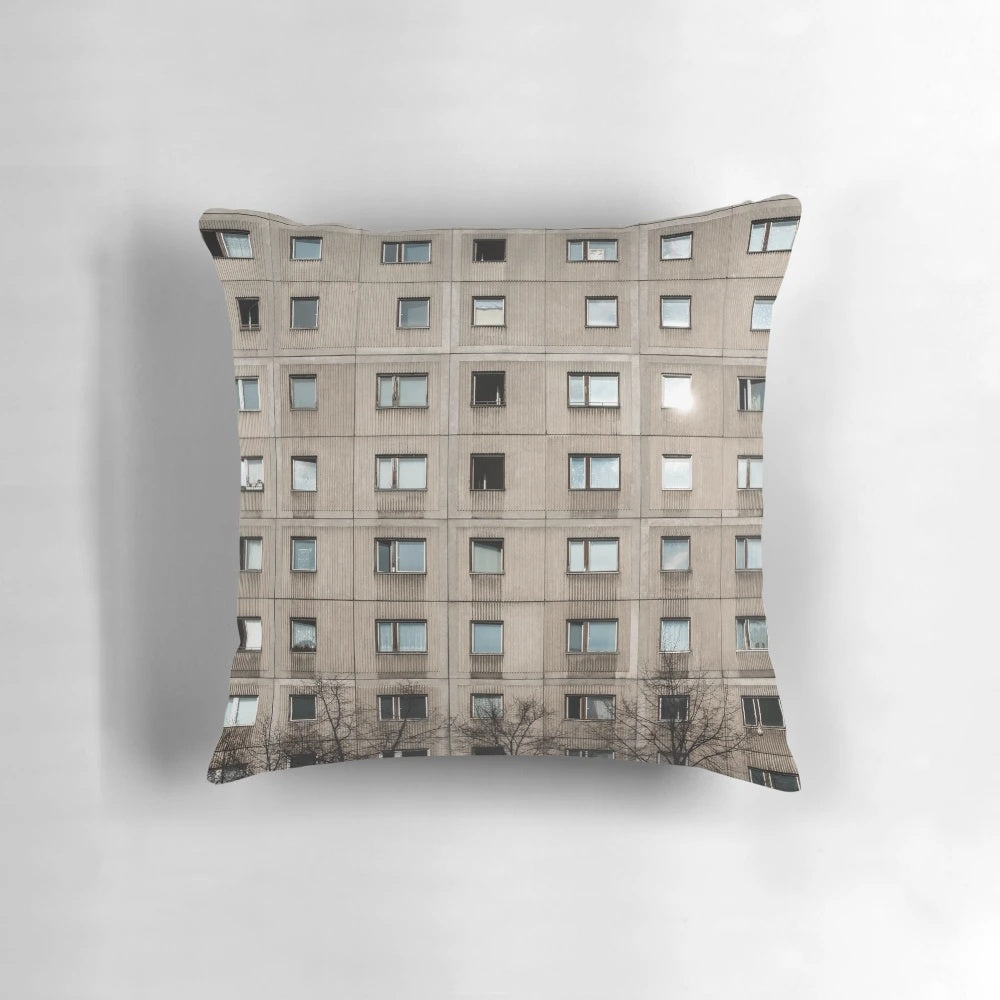 Plattenbau-style concrete building facade, featuring windows and slabs of concrete