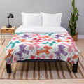 Colorful plush blanket with balloon dog and confetti pattern