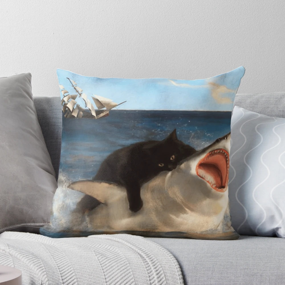 A whimsical illustration of a black kitten playfully attacking a great white shark on a decorative pillow.