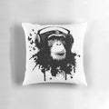 Colorful pillow featuring a vibrant monkey-inspired pattern with splashes, butterflies, and headphones