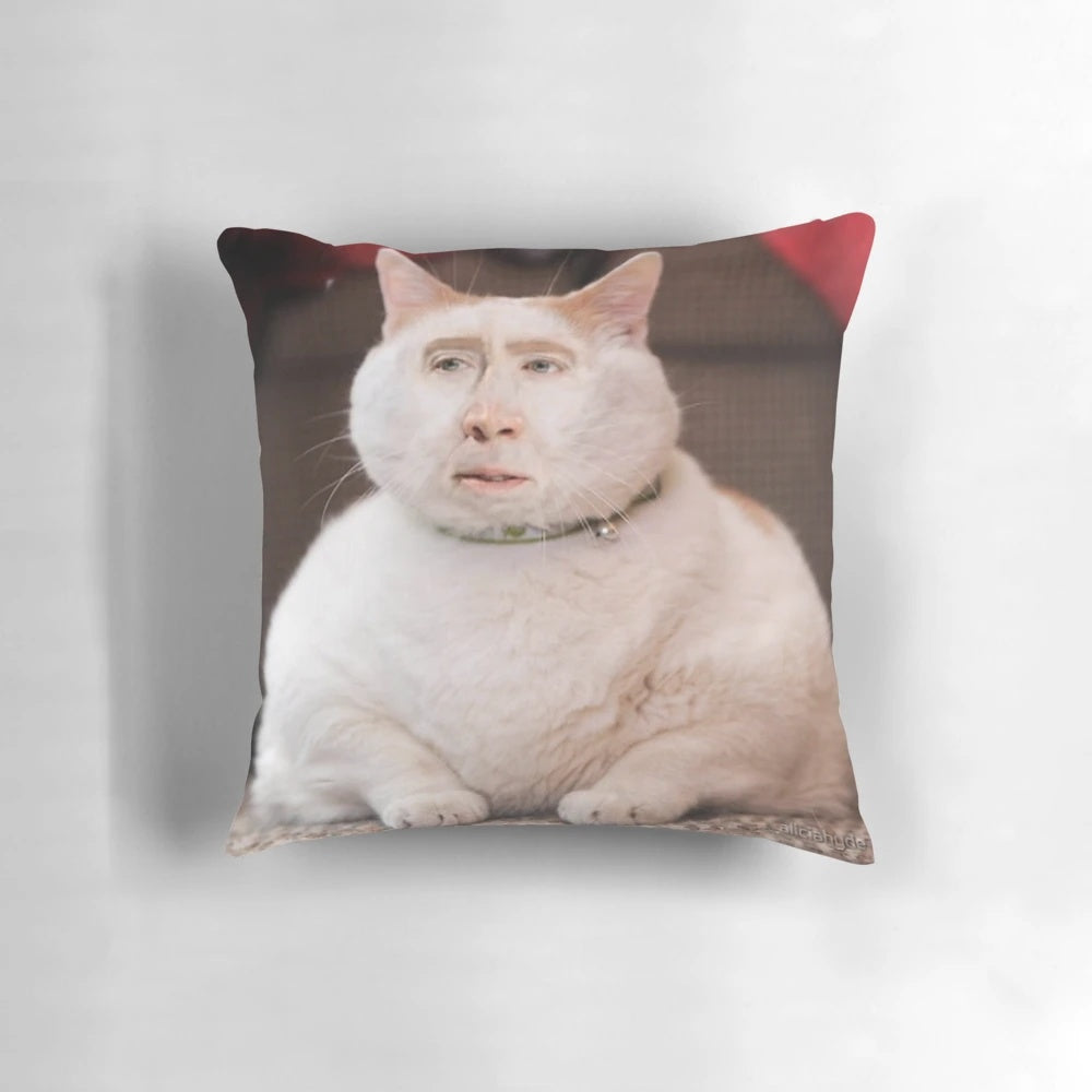 Whimsical pillow featuring a photoshopped image of Nicolas Cage's face on a cat
