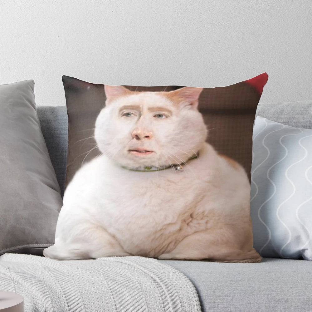 Whimsical pillow featuring a photoshopped image of Nicolas Cage's face on a cat
