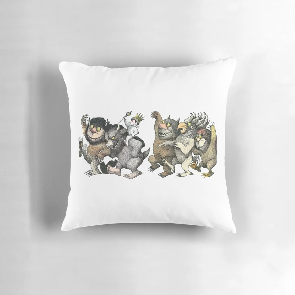 A throw pillow featuring a whimsical graphic design of the "wild things" characters.