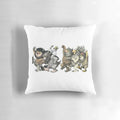 A throw pillow featuring a whimsical graphic design of the "wild things" characters.