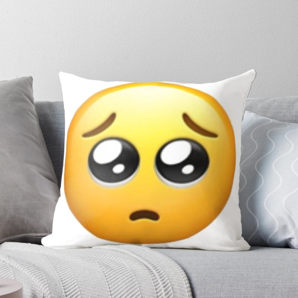 Pleading big eyes emoji printed on a soft, plush throw pillow