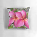 Vibrant plumeria flowers printed on a decorative pillow for a Hawaiian-inspired touch.