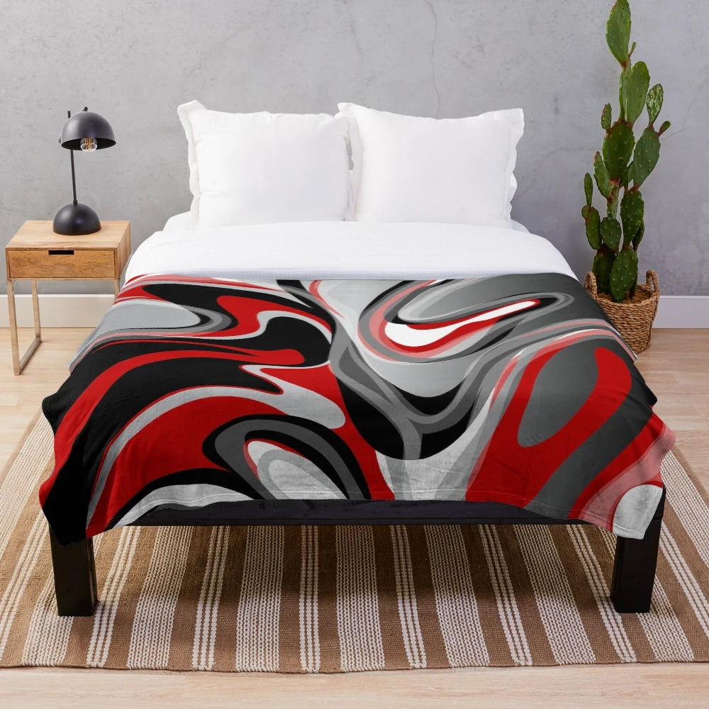 Plush blanket with abstract, fluid, marbled design in red, gray, black, and white colors