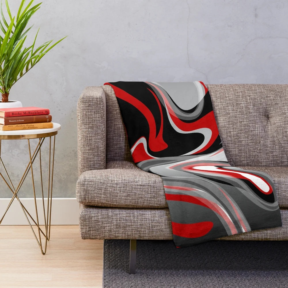 Plush blanket with abstract, fluid, marbled design in red, gray, black, and white colors