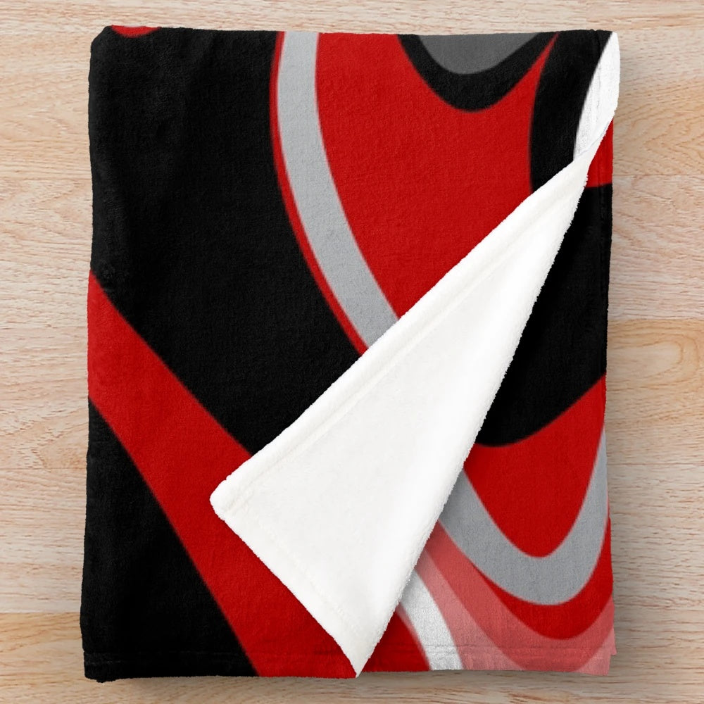 Plush blanket with abstract, fluid, marbled design in red, gray, black, and white colors