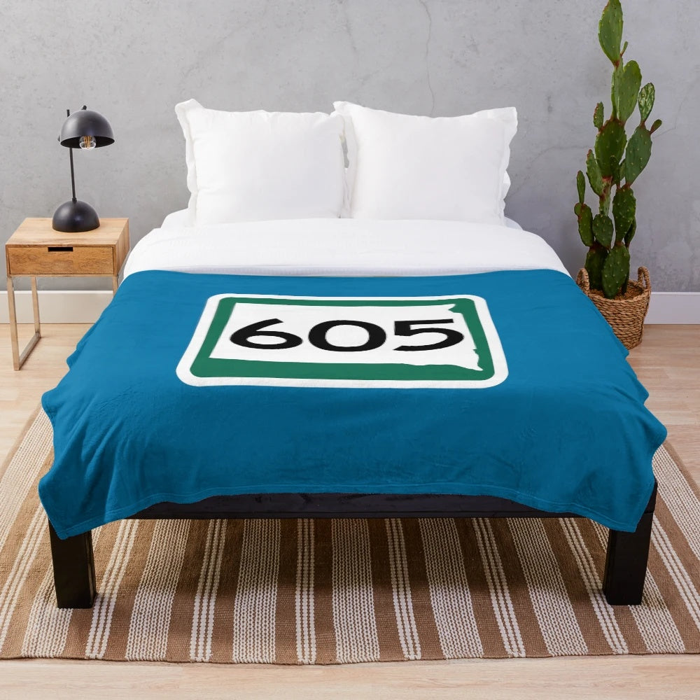Plush blanket featuring the area code 605 and iconic South Dakota landmarks