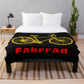 Plush blanket with a bicycle design inspired by travels in Germany
