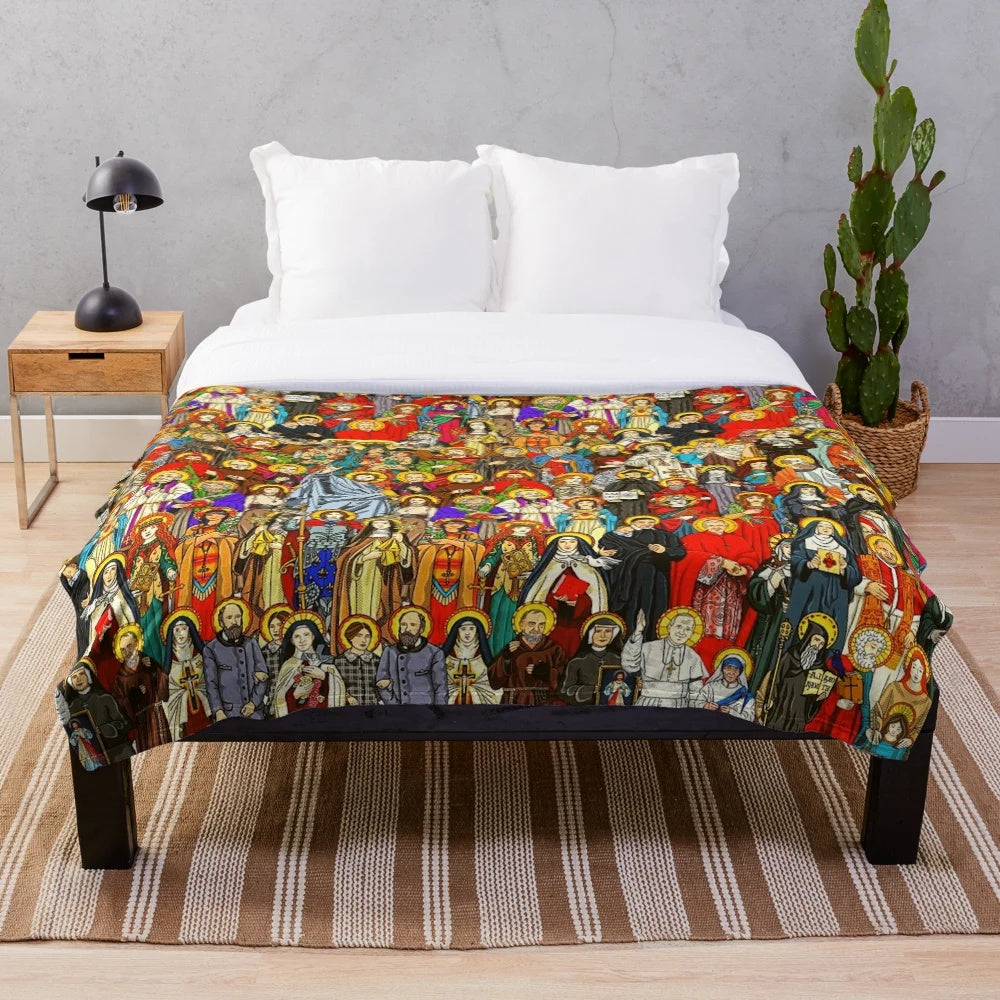 Plush blanket with images of Catholic saints, Jesus Christ, and religious symbols