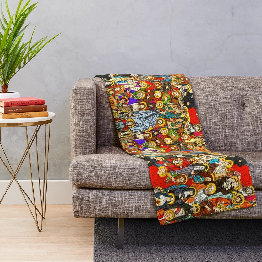 Plush blanket with images of Catholic saints, Jesus Christ, and religious symbols