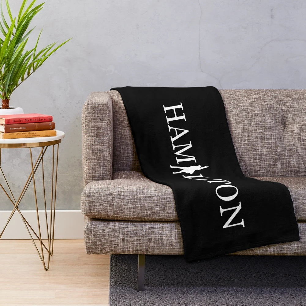 Plush blanket with Hamilton the Musical inspired graphics and text