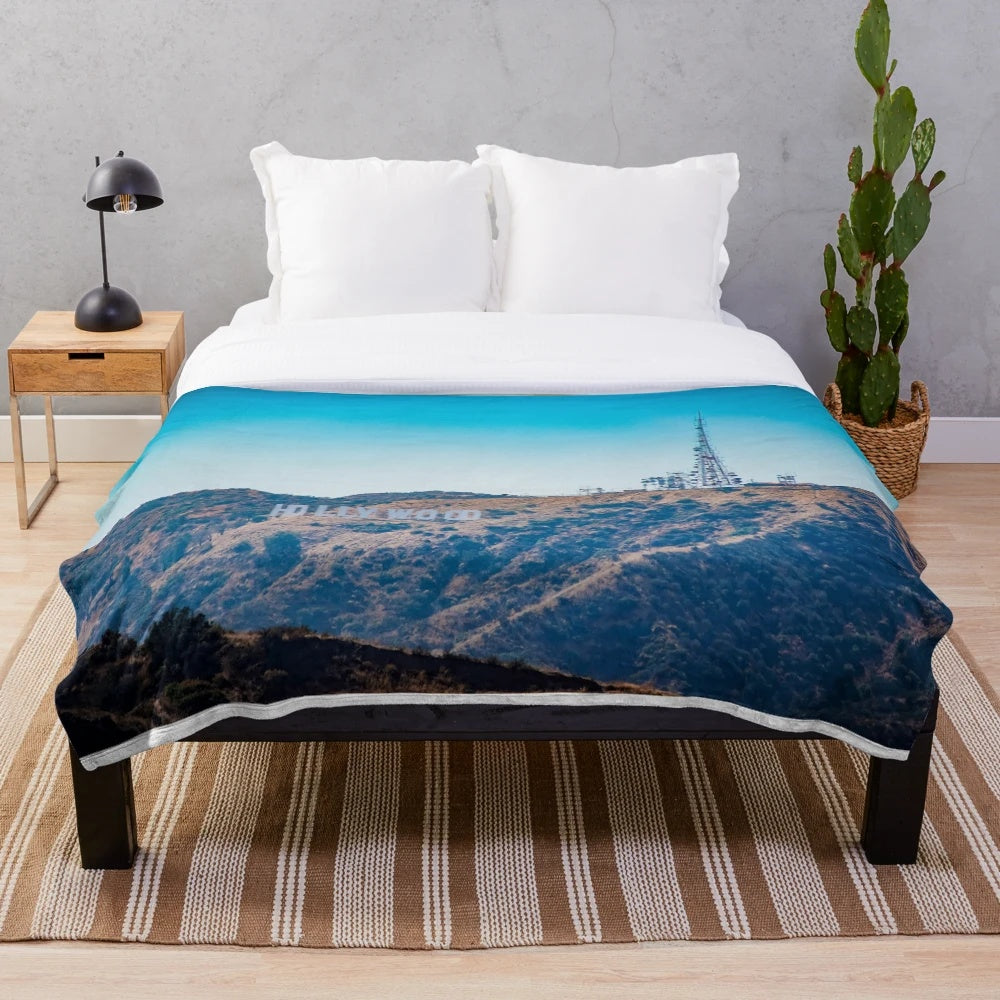 A plush blanket with the iconic Hollywood sign against a scenic Los Angeles landscape
