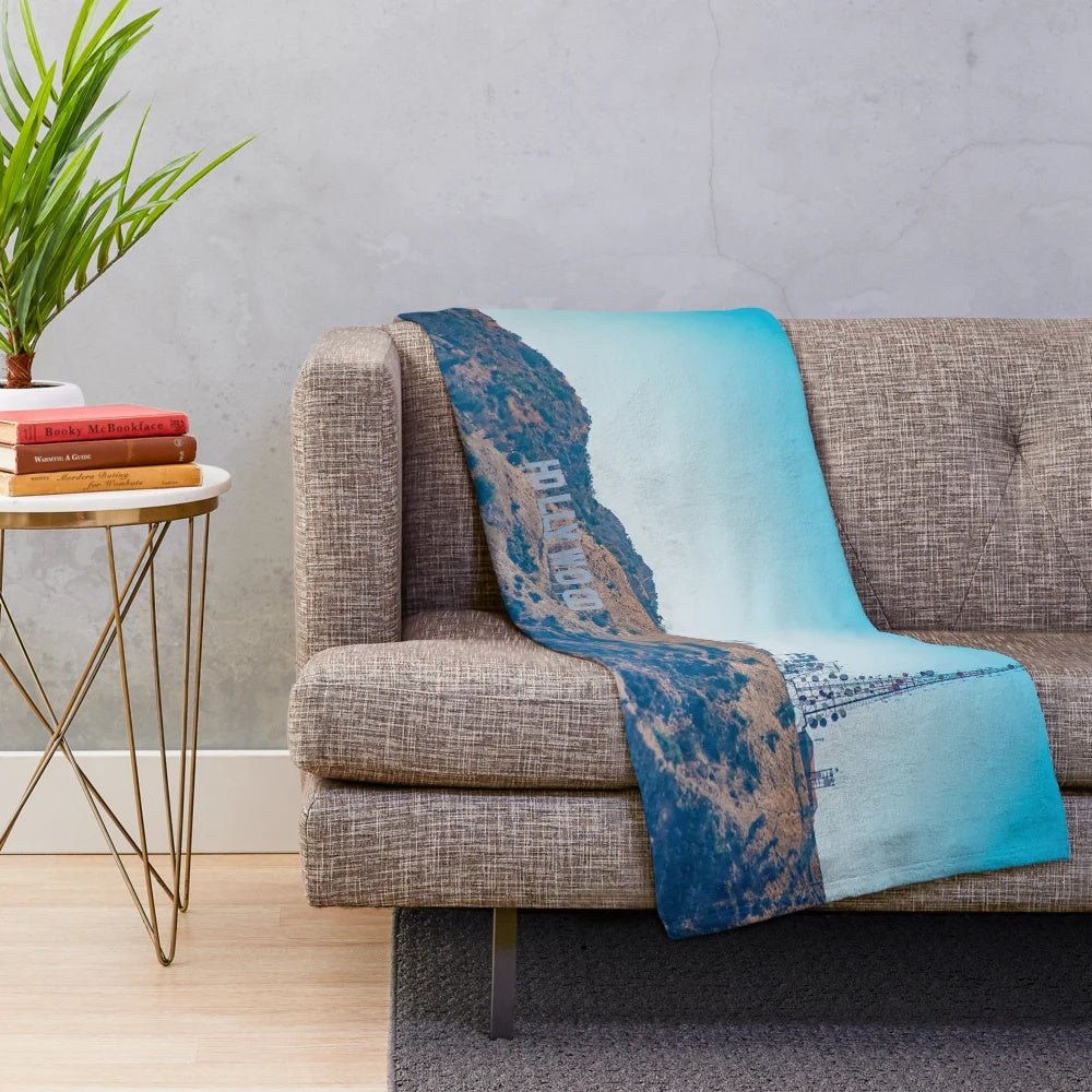 A plush blanket with the iconic Hollywood sign against a scenic Los Angeles landscape