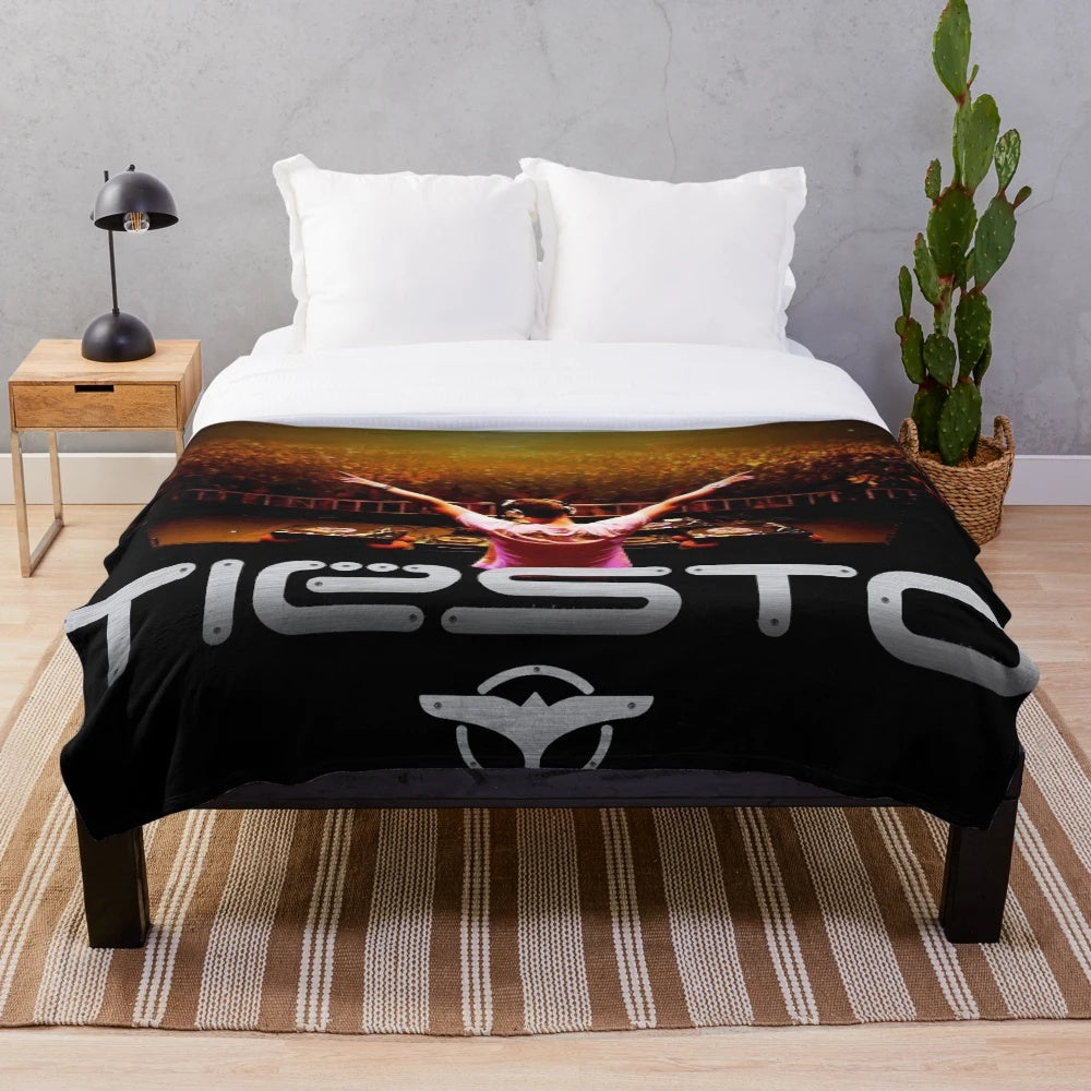 Plush blanket with Tiesto's image and branding