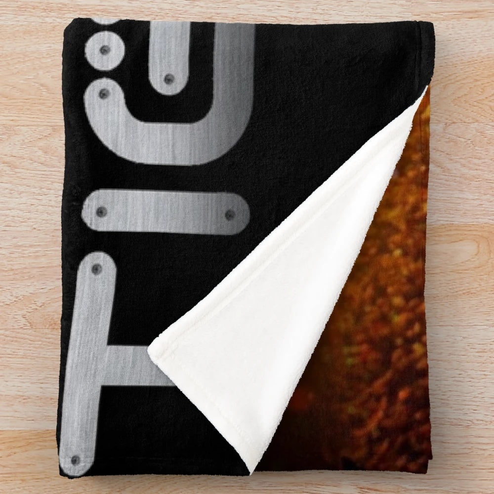 Plush blanket with Tiesto's image and branding