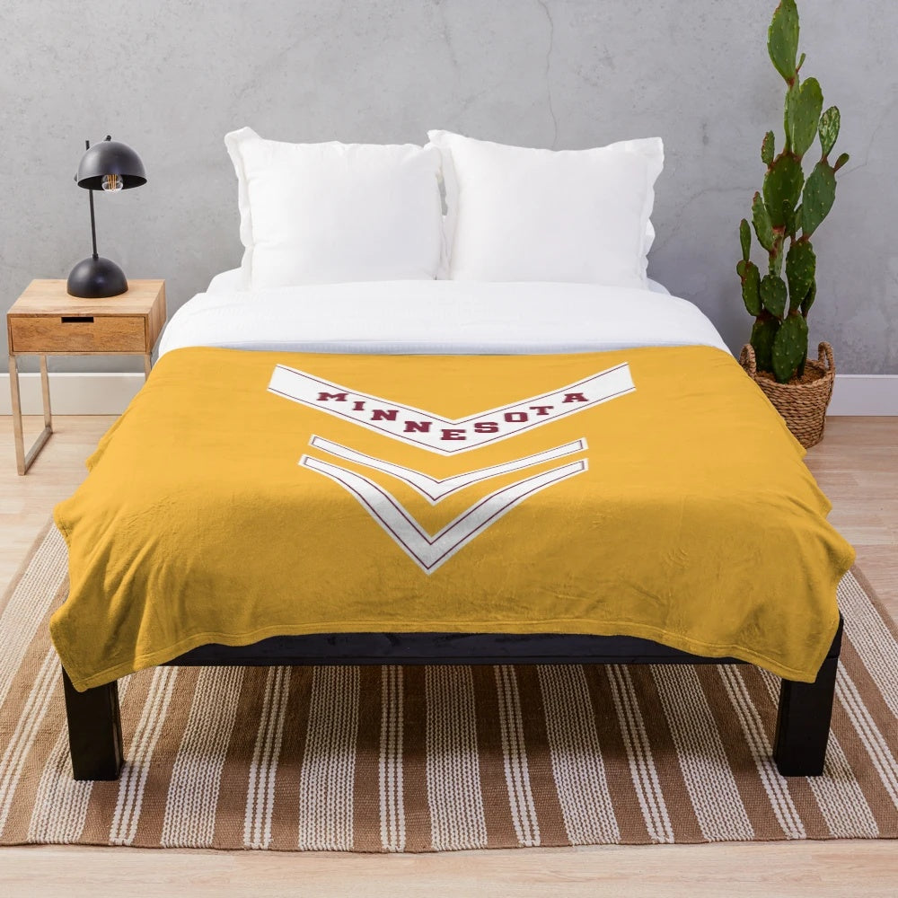 Plush blanket with University of Minnesota marching band uniform chevron design