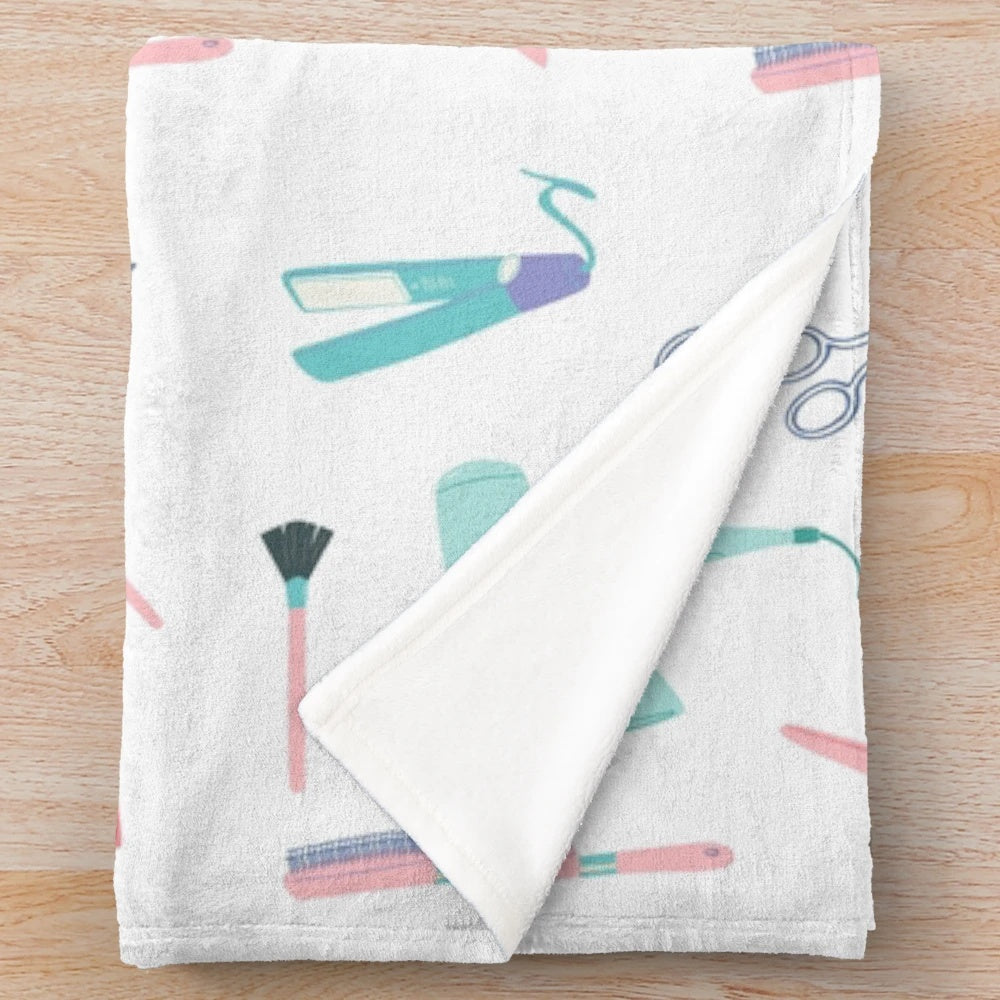 Plush blanket with cosmetology-themed design including hair, nails, and beauty tools