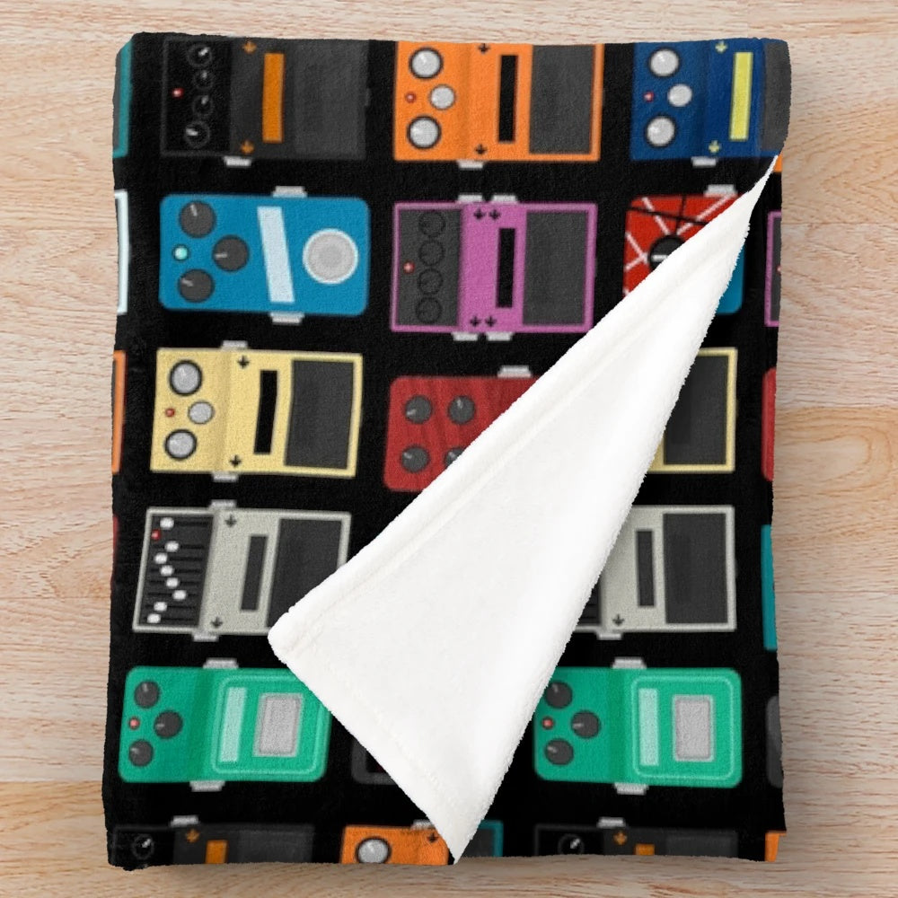Plush blanket with guitar pedal design