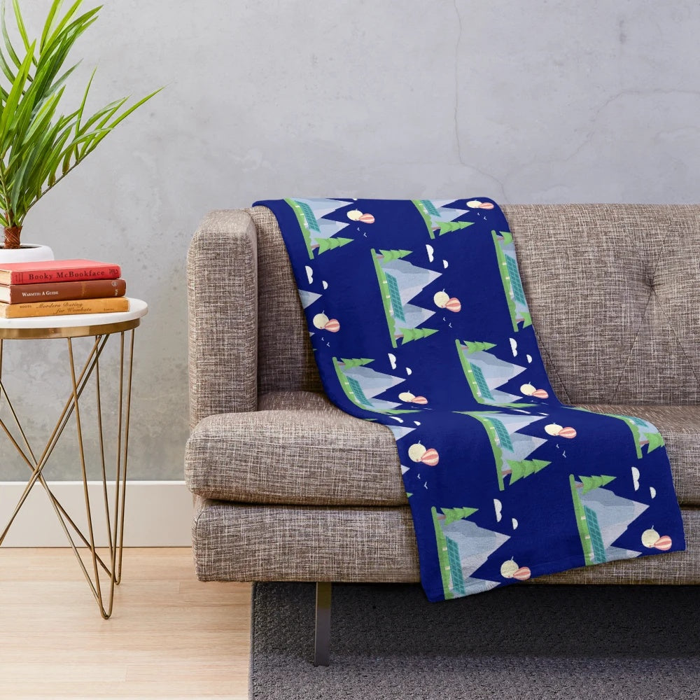 Plush mountain and paragliding themed blanket