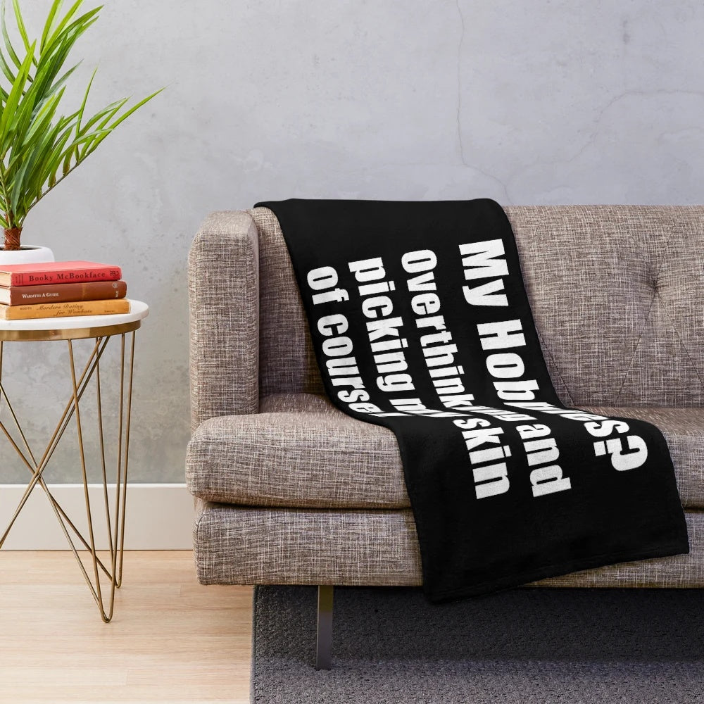 Plush blanket with the text "My hobbies overthinking and picking my skin of course