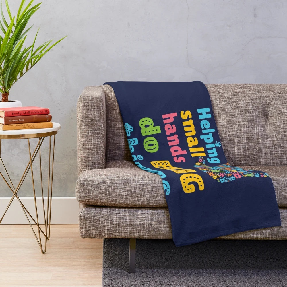 Plush blanket with "Helping Small Hands Do Big Things" design for pediatric occupational therapists