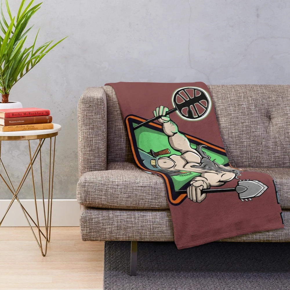 Old man with a metal detector and a plush blanket