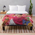 Frida Kahlo-inspired plush blanket featuring flowers, butterflies, and the iconic blue house
