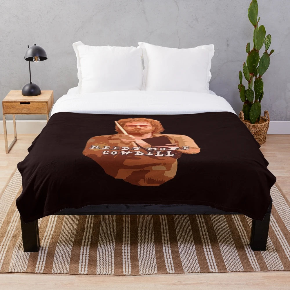 Plush blanket with "More Cowbell" design inspired by the popular SNL sketch