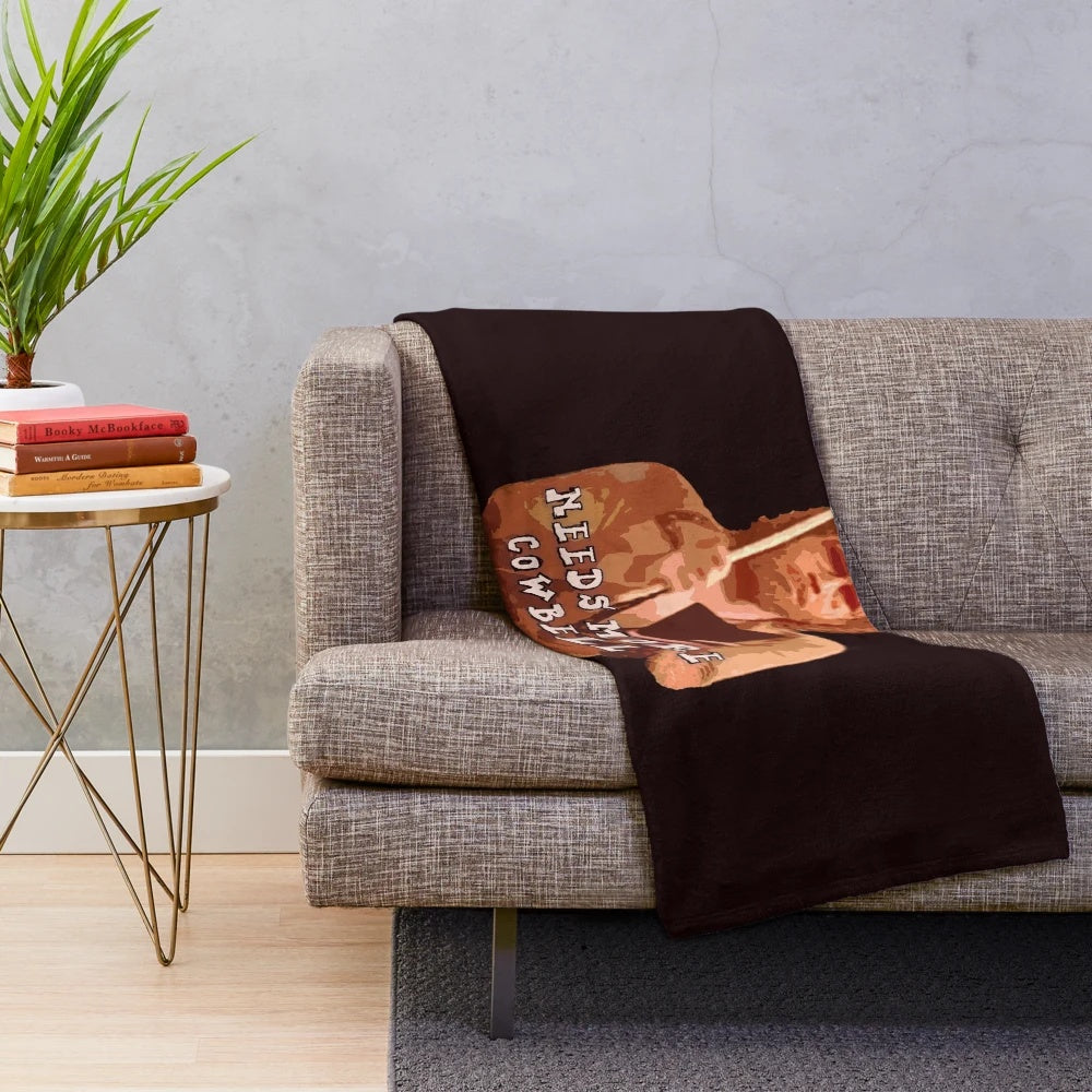 Plush blanket with "More Cowbell" design inspired by the popular SNL sketch