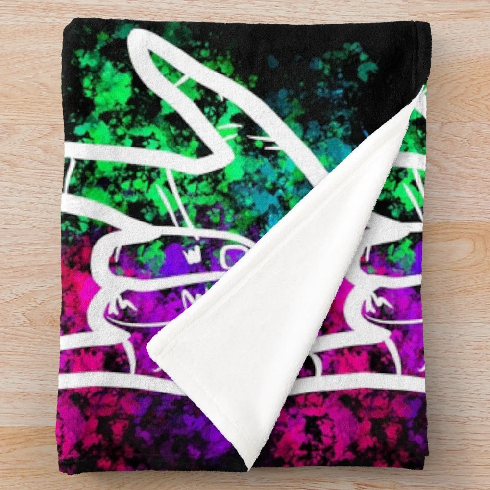 Soft plush blanket featuring a splatter paint design of the American Sign Language "I Love You" sign