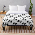 Plush blanket with black and white image of ASL interpreter hand symbols