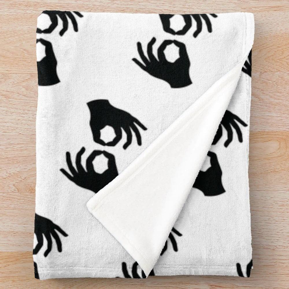 Plush blanket with black and white image of ASL interpreter hand symbols