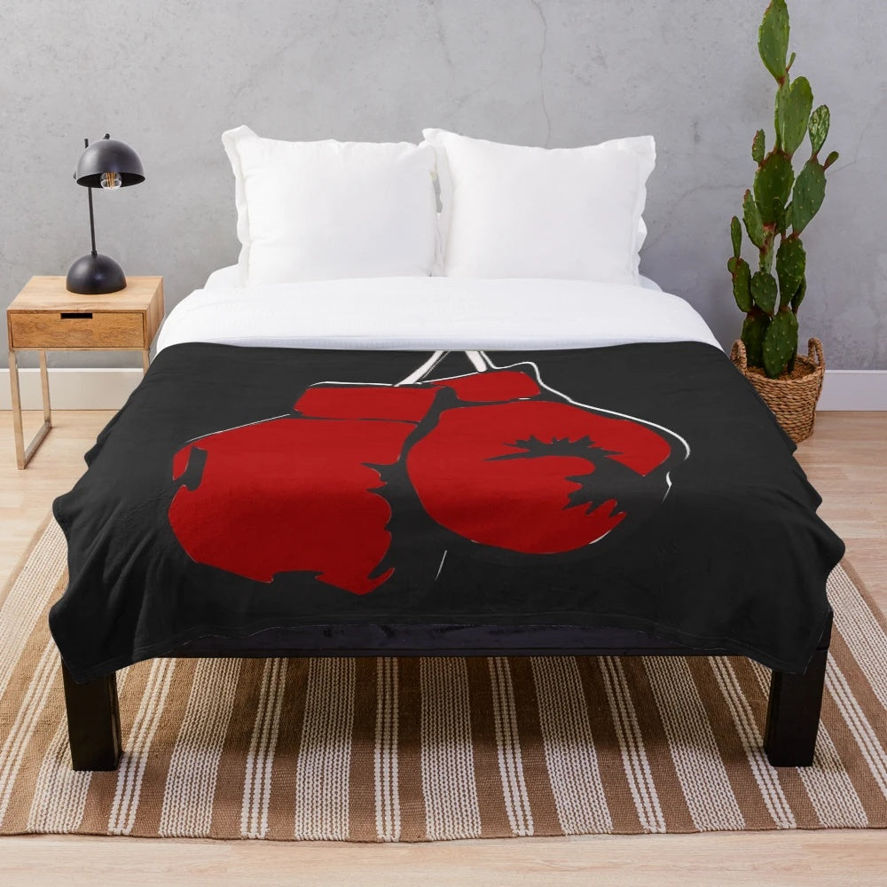 Plush blanket with red boxing gloves design
