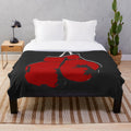 Plush blanket with red boxing gloves design
