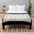 Plush throw blanket featuring a light ivory blueprint design of an F1 race track
