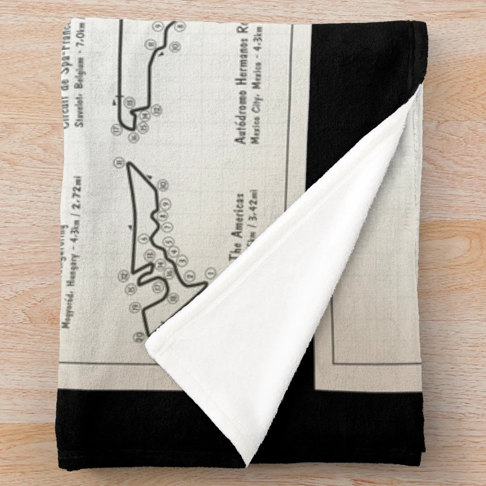 Plush throw blanket featuring a light ivory blueprint design of an F1 race track