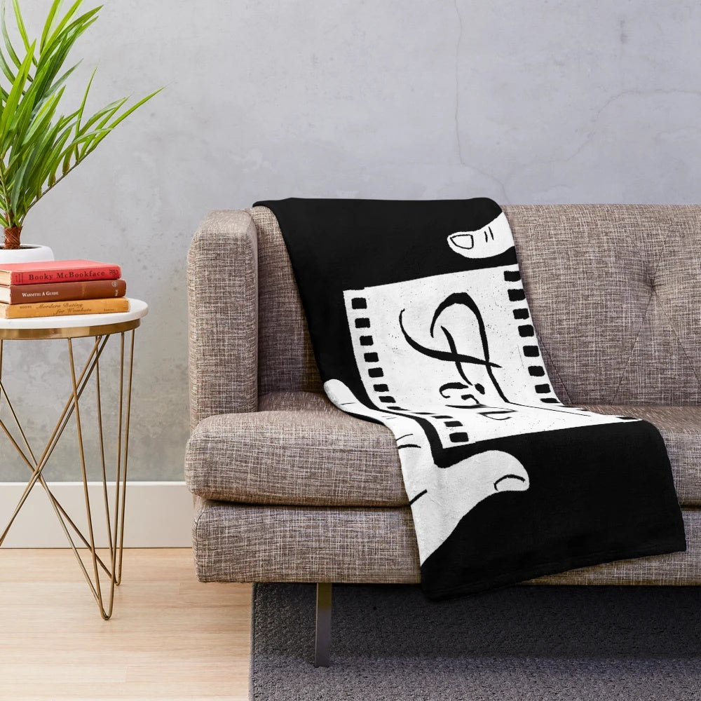 Plush blanket with original linocut design featuring hands in a "fin" or "the end" movie gesture