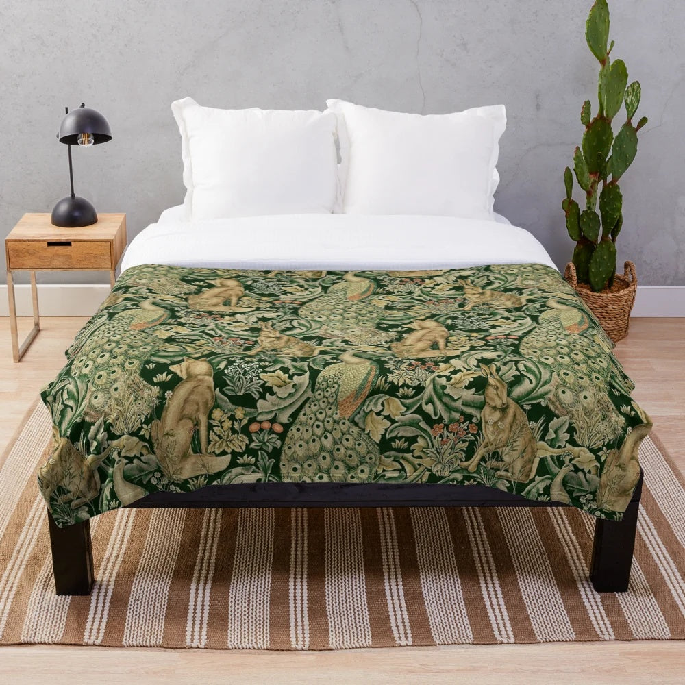 Plush blanket featuring green forest animals, peacocks, and a floral pattern