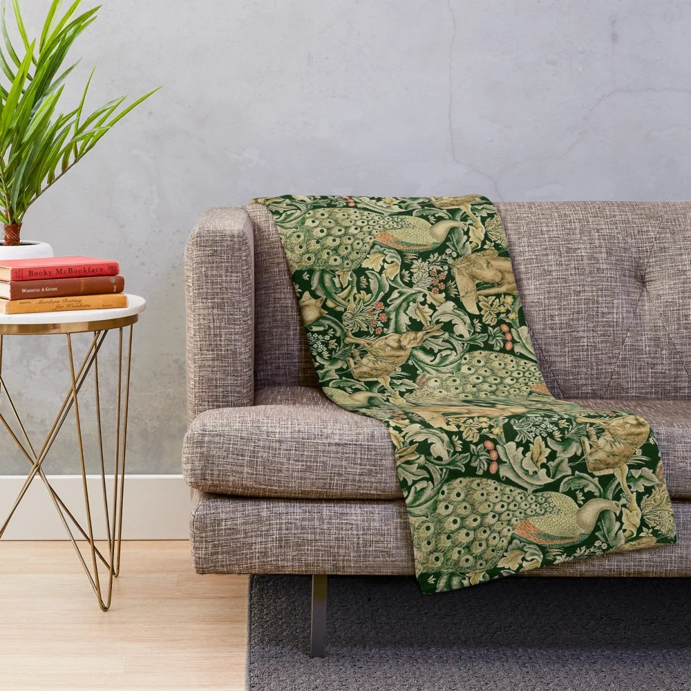 Plush blanket featuring green forest animals, peacocks, and a floral pattern
